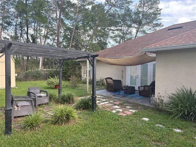 a view of backyard with patio