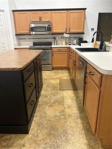 a kitchen with a sink stove and refrigerator