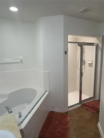 a bathroom with a tub and shower