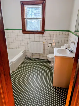 a bathroom with a sink a toilet and bathtub