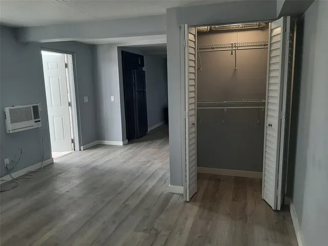 a view of a room with wooden floor