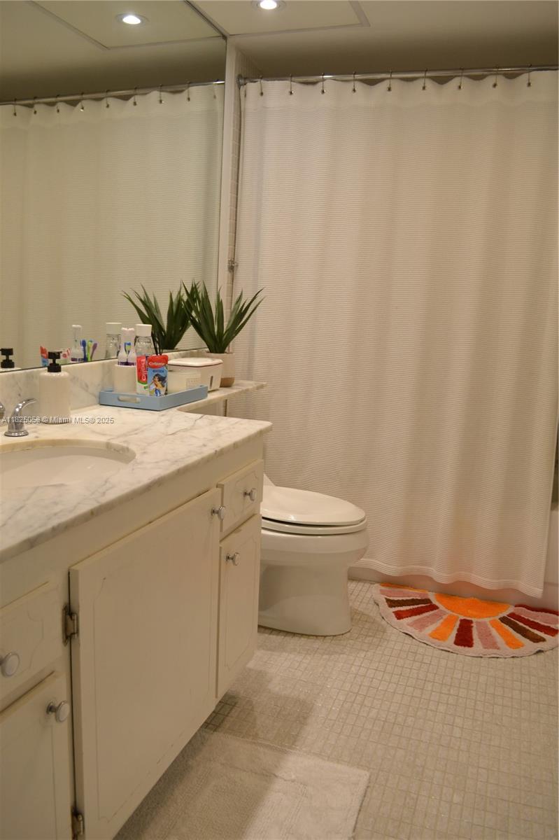 1111 Crandon Boulevard, Unit C402 Key Biscayne, FL 33149 - Photo 13 of 32 a bathroom with a toilet and a sink
