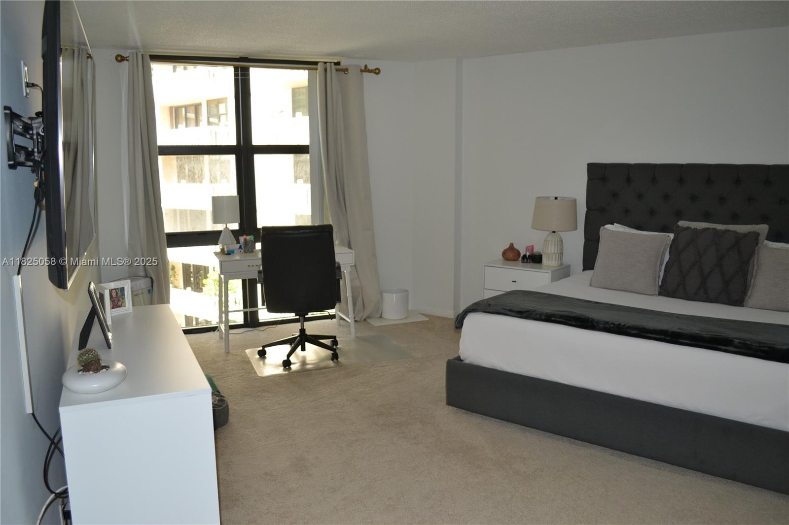 1111 Crandon Boulevard, Unit C402 Key Biscayne, FL 33149 - Photo 15 of 32 a living room with furniture and a flat screen tv