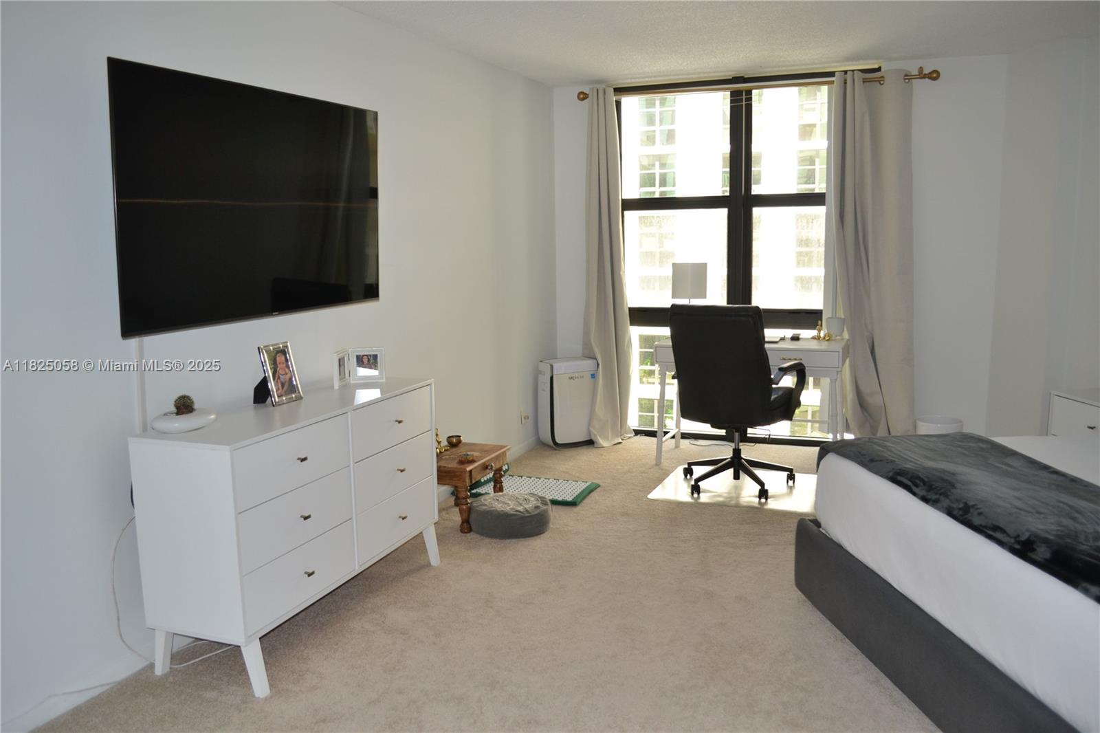 1111 Crandon Boulevard, Unit C402 Key Biscayne, FL 33149 - Photo 17 of 32 a living room with furniture and a flat screen tv