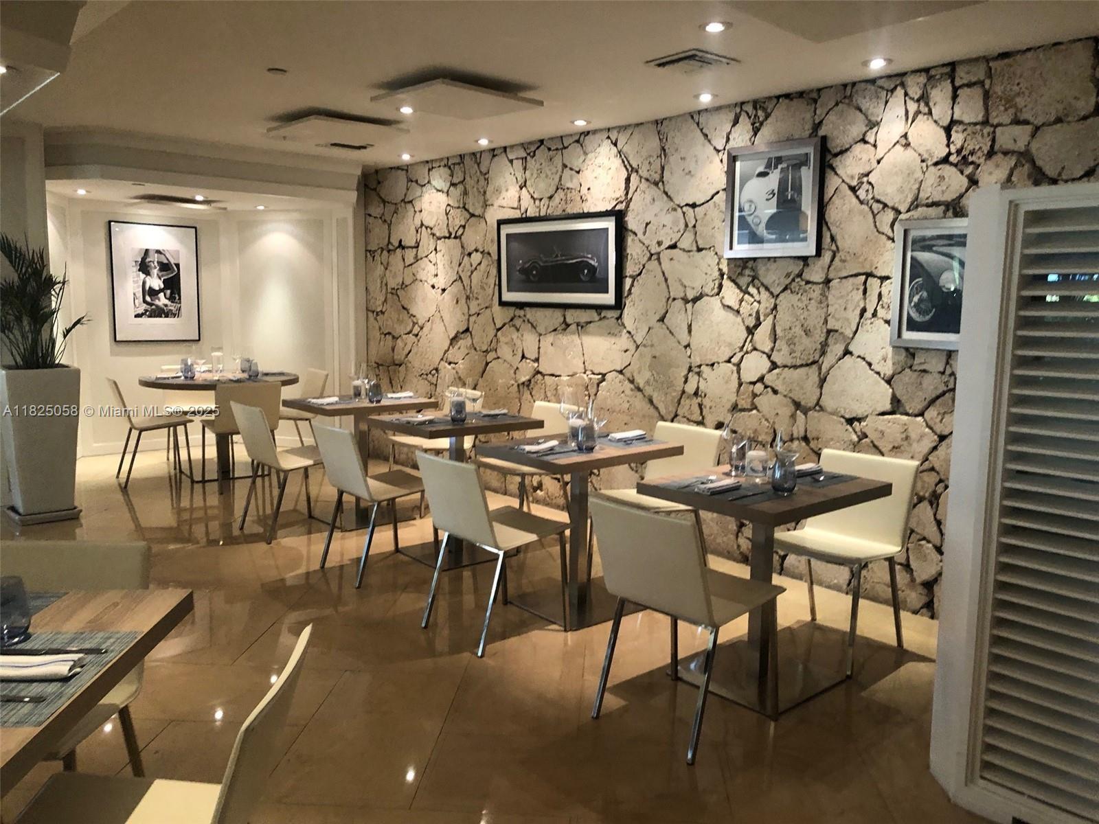 1111 Crandon Boulevard, Unit C402 Key Biscayne, FL 33149 - Photo 25 of 32 a view of a dining room with furniture and wooden floor