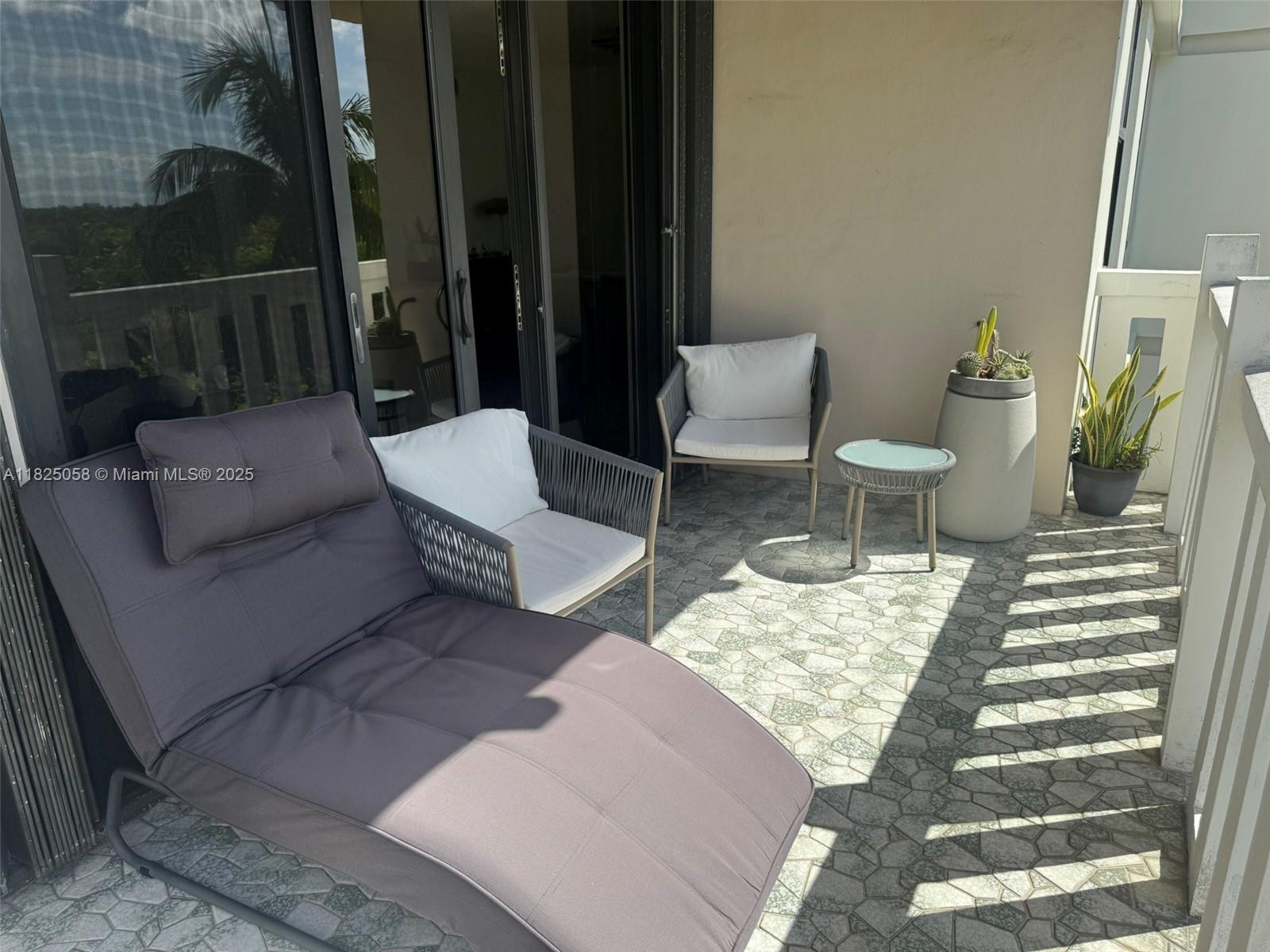 1111 Crandon Boulevard, Unit C402 Key Biscayne, FL 33149 - Photo 5 of 32 a view of a patio with couches and a potted plant on a table
