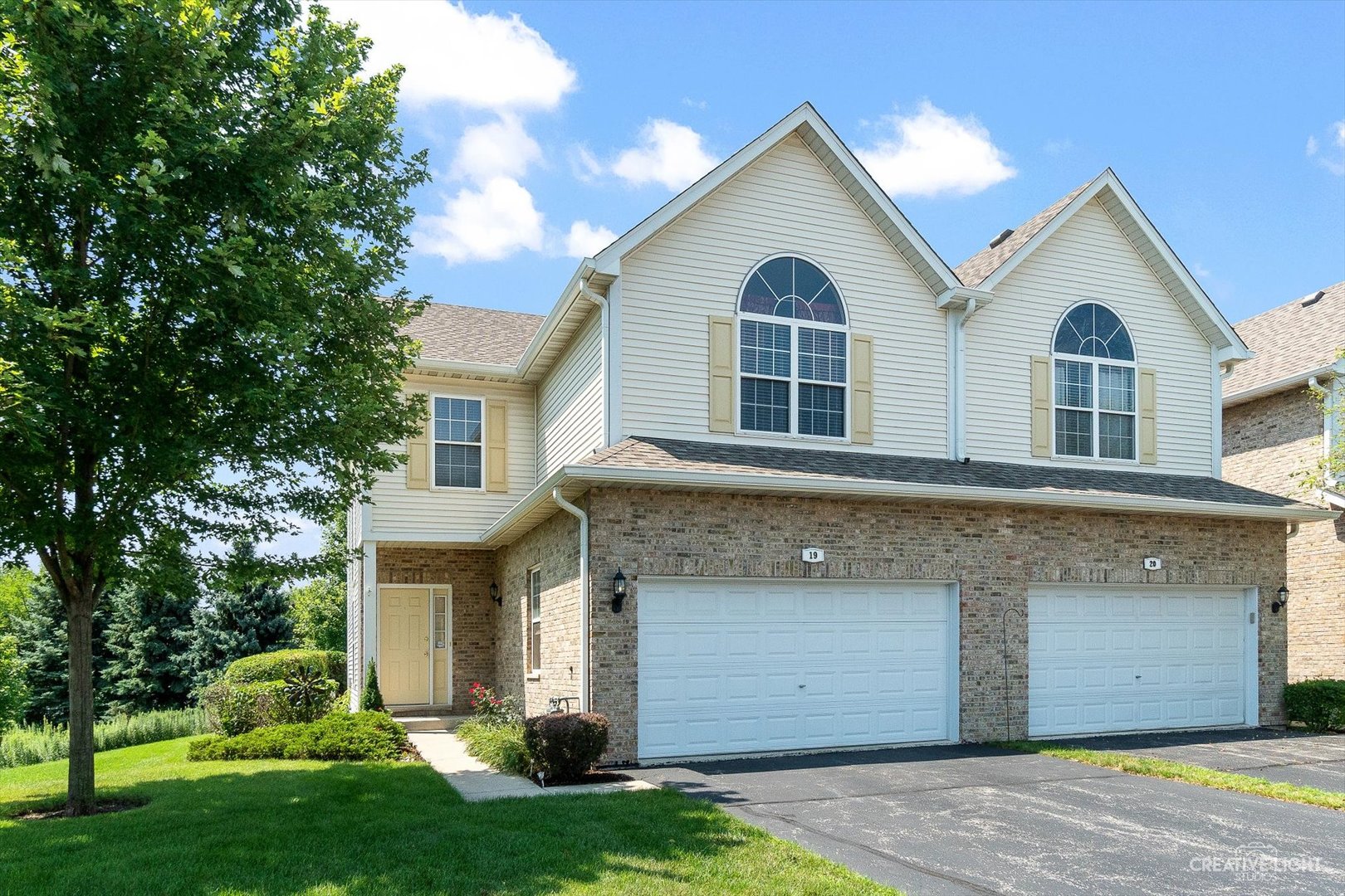 19 Lily Court Bolingbrook, IL 60440 - Photo 1 of 31 a view of a white house with a small yard and large tree