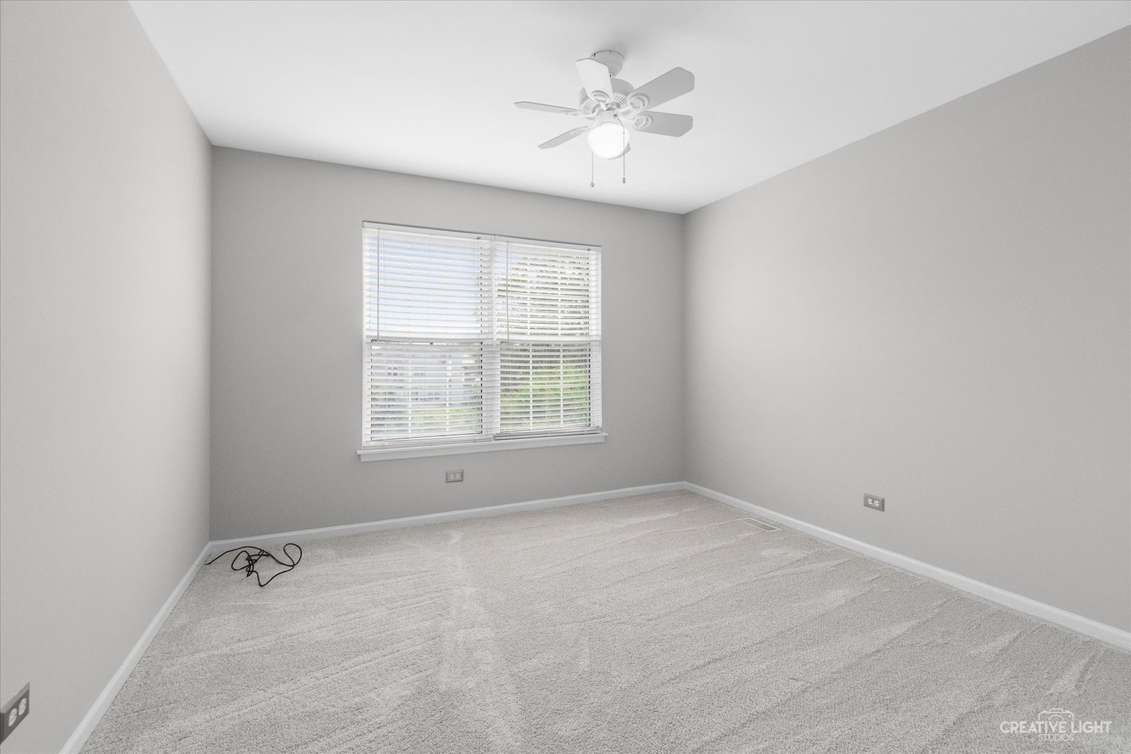 19 Lily Court Bolingbrook, IL 60440 - Photo 18 of 31 an empty room with a window and a ceiling fan