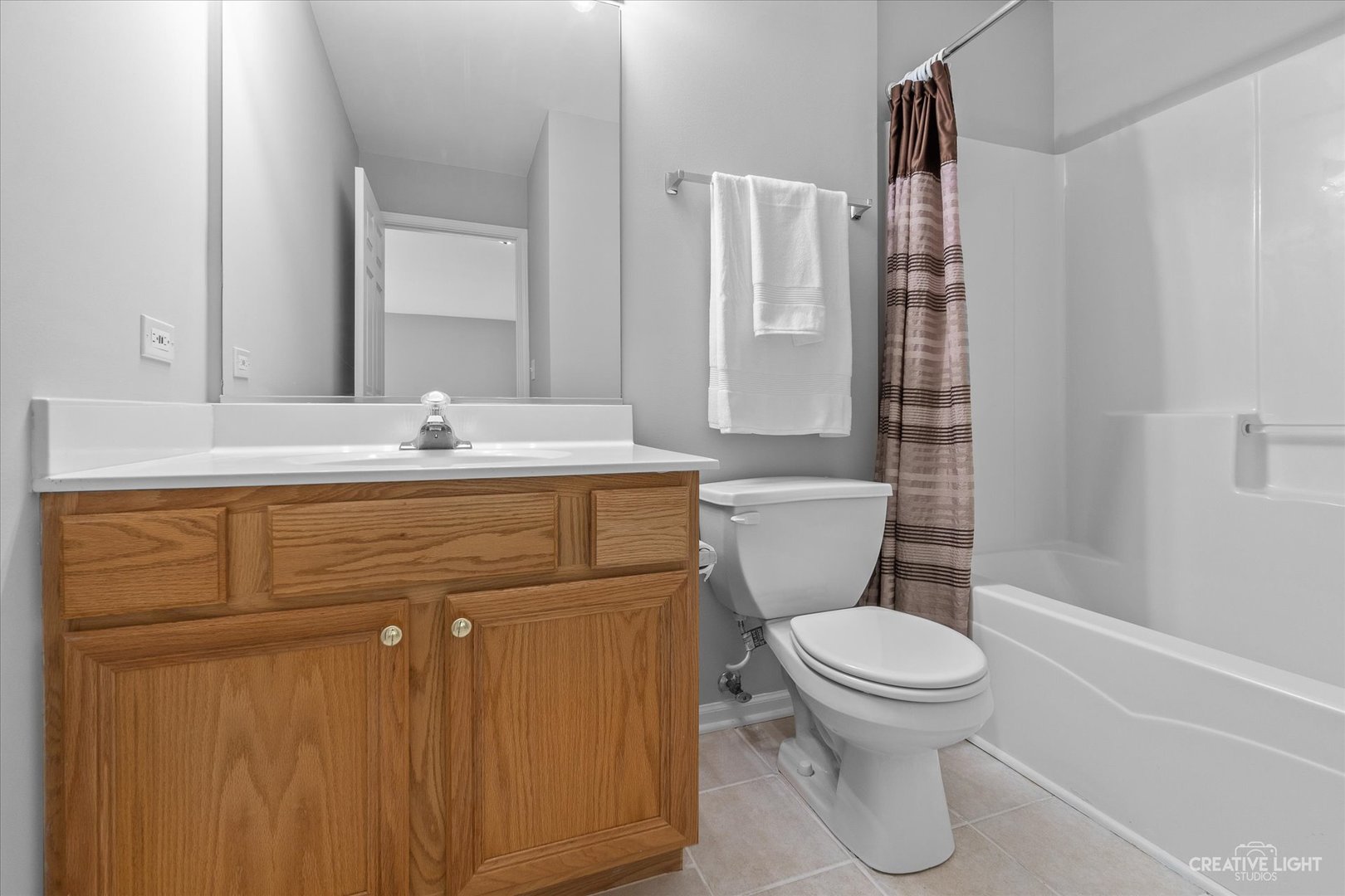 19 Lily Court Bolingbrook, IL 60440 - Photo 19 of 31 a bathroom with a sink a toilet a mirror and shower