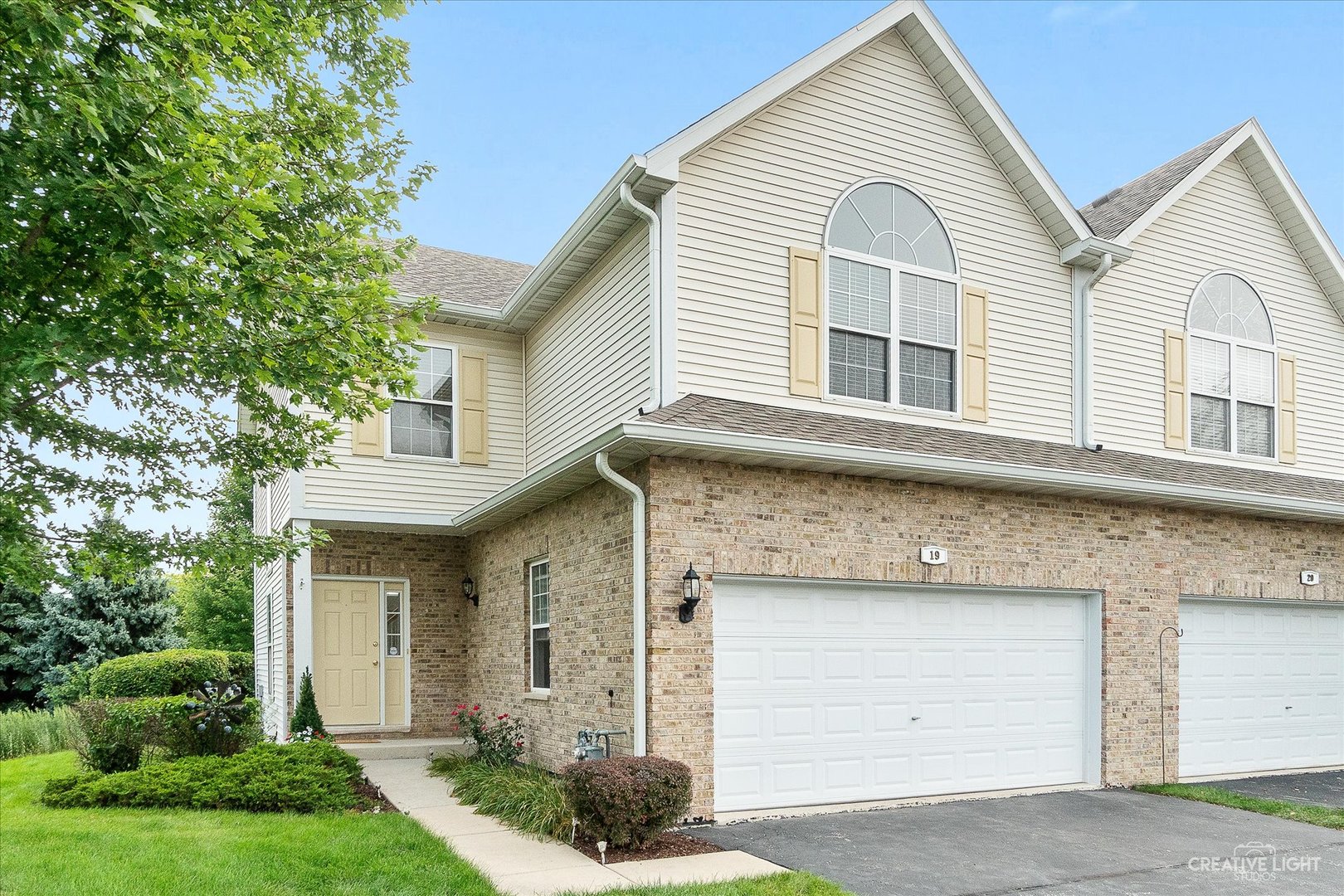19 Lily Court Bolingbrook, IL 60440 - Photo 2 of 31 a view of a white house with large windows and a small yard
