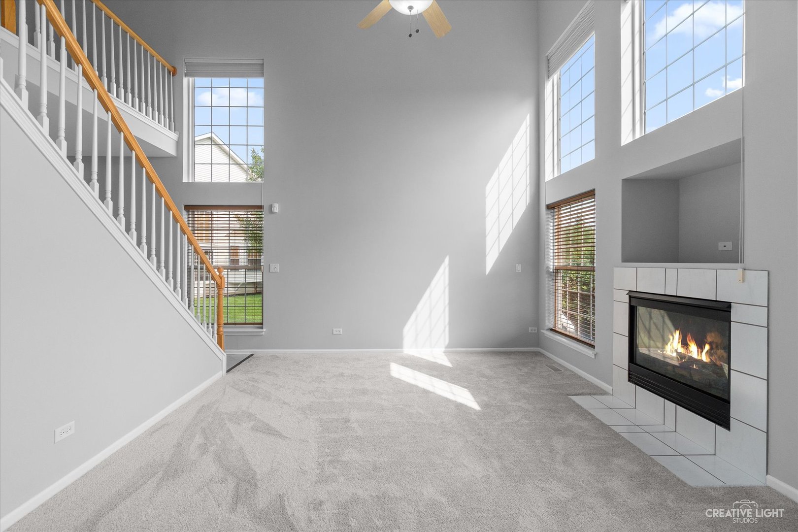 19 Lily Court Bolingbrook, IL 60440 - Photo 7 of 31 a view of an empty room with fireplace and stairs
