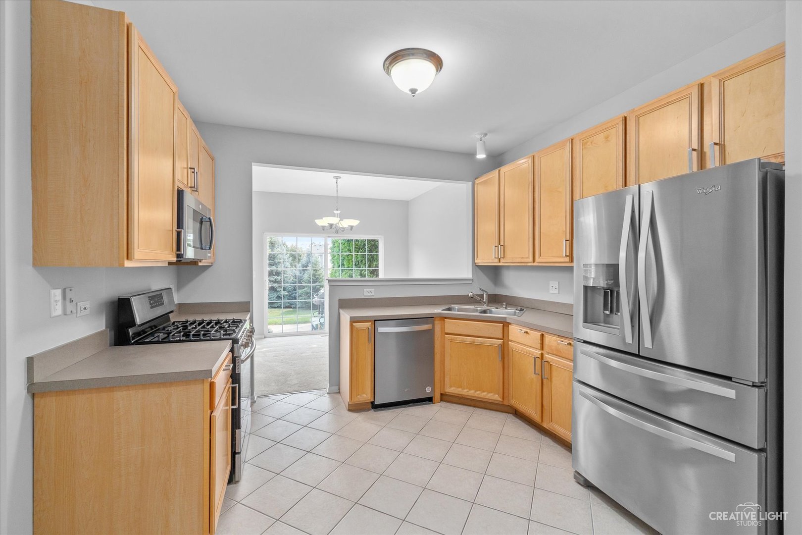 19 Lily Court Bolingbrook, IL 60440 - Photo 9 of 31 a kitchen with stainless steel appliances granite countertop a refrigerator and a stove