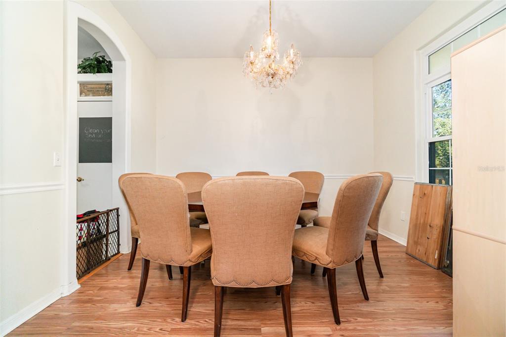 22631 Robbins Road Astatula, FL 34705 - Photo 12 of 35 a view of a dining room with furniture and wooden floor