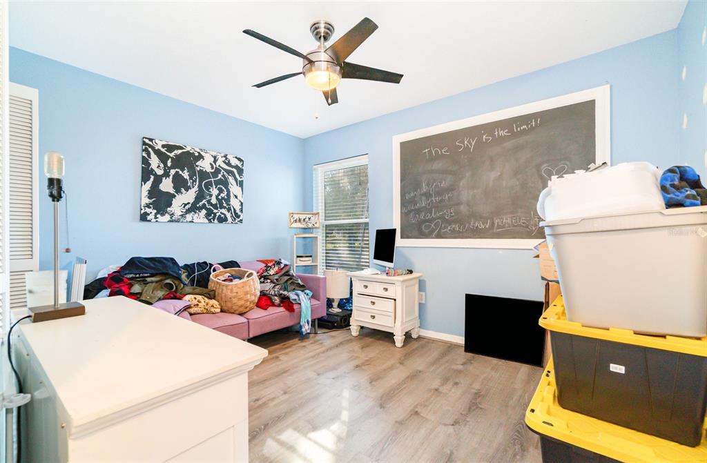 22631 Robbins Road Astatula, FL 34705 - Photo 14 of 35 a bedroom with furniture and a bed