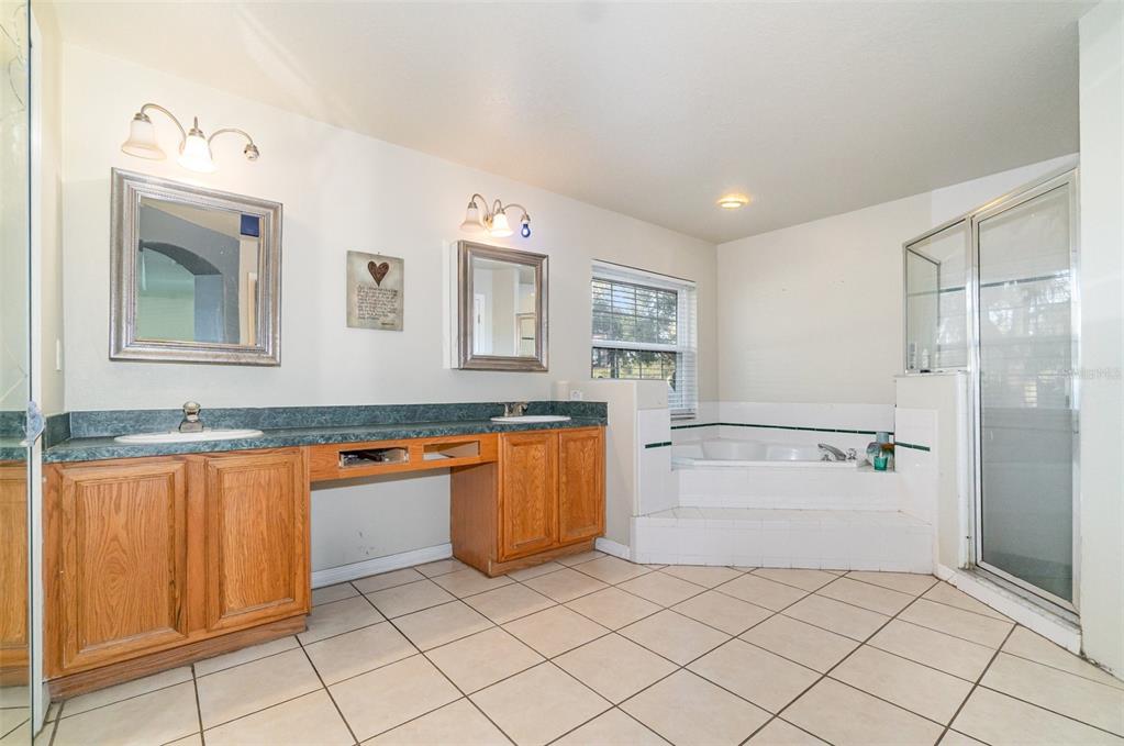 22631 Robbins Road Astatula, FL 34705 - Photo 18 of 35 a kitchen with stainless steel appliances granite countertop a refrigerator and a sink