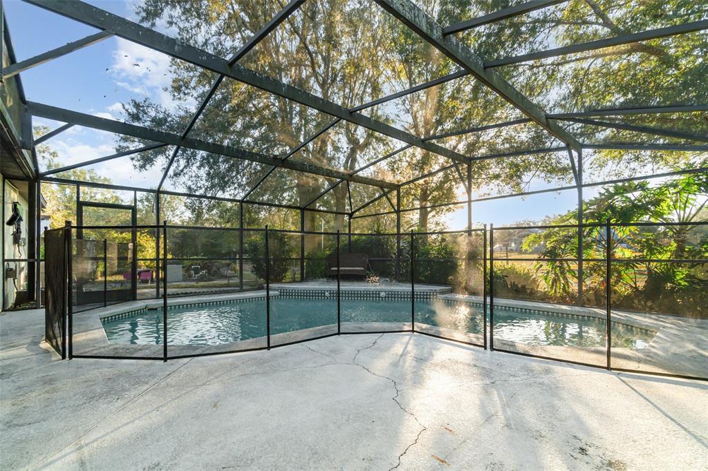 22631 Robbins Road Astatula, FL 34705 - Photo 22 of 35 a view of empty room with wooden floor and iron fence