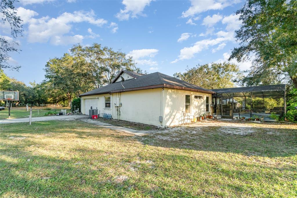 22631 Robbins Road Astatula, FL 34705 - Photo 24 of 35 a view of a house with a yard and garage