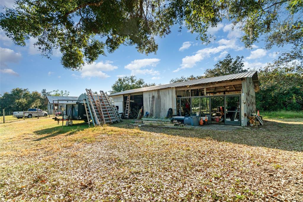 22631 Robbins Road Astatula, FL 34705 - Photo 30 of 35 a view of a house with backyard porch and sitting area