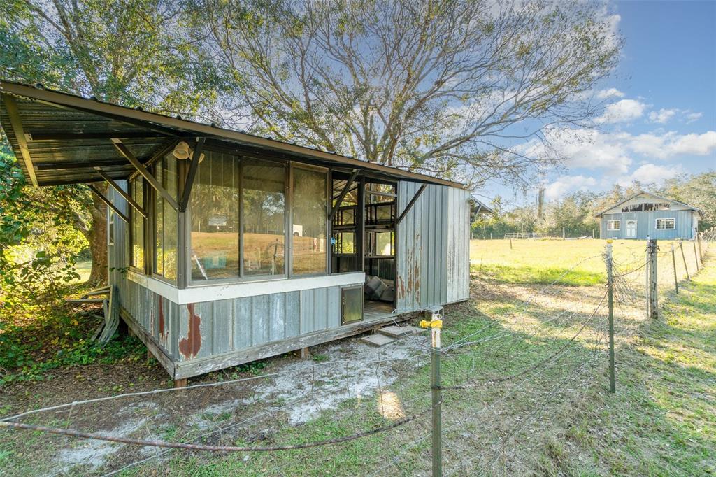 22631 Robbins Road Astatula, FL 34705 - Photo 31 of 35 a backyard of a house with a fountain and outdoor seating