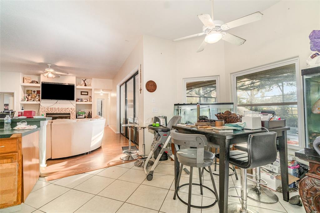 22631 Robbins Road Astatula, FL 34705 - Photo 9 of 35 a view of a dining room with furniture and wooden floor