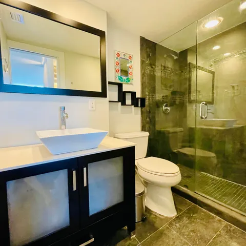 a white toilet sitting next to a white wall