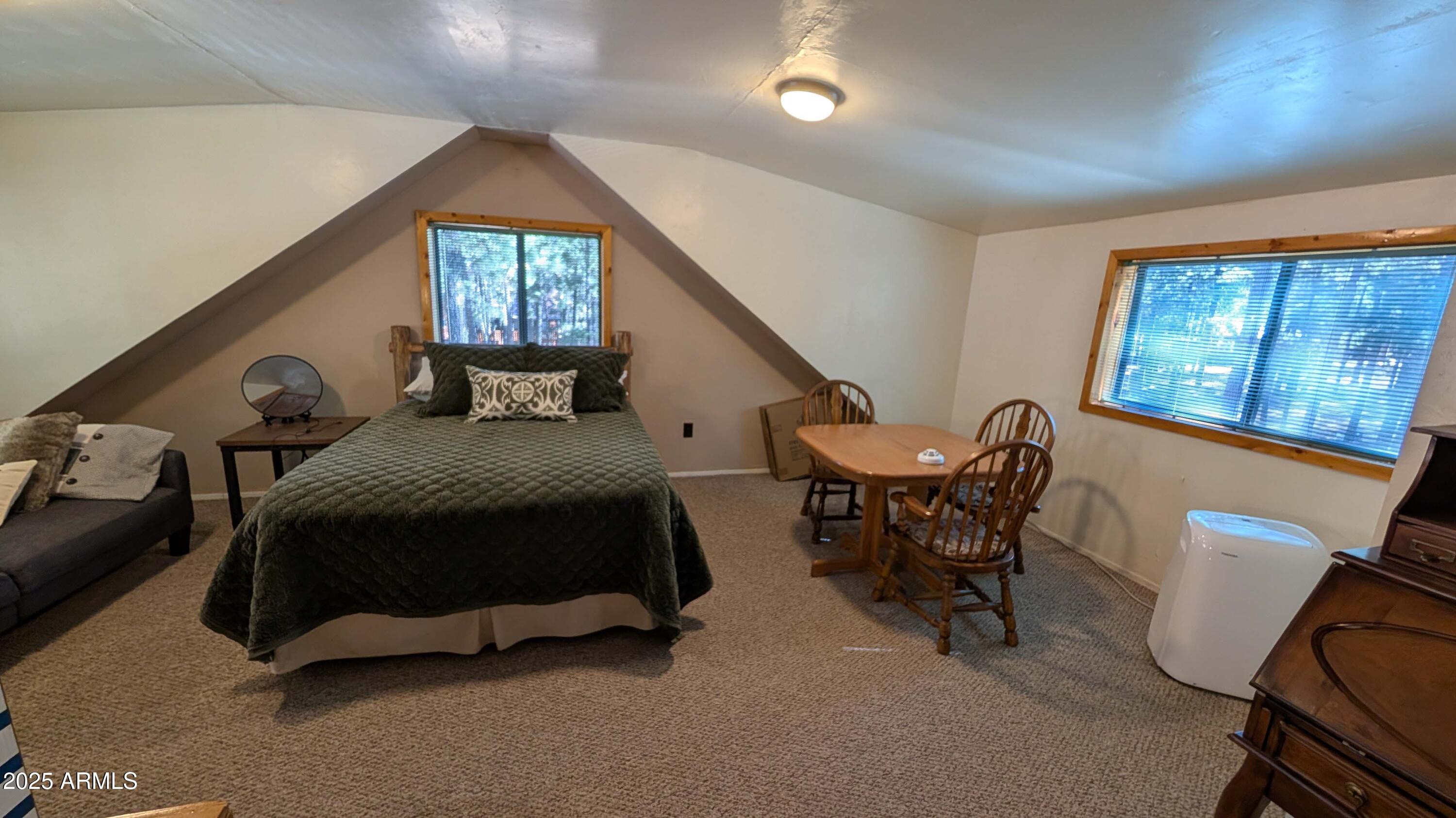 2425 Tall Trees Loop Forest Lakes, AZ 85931 - Photo 15 of 43 a spacious bedroom with a bed and a chair