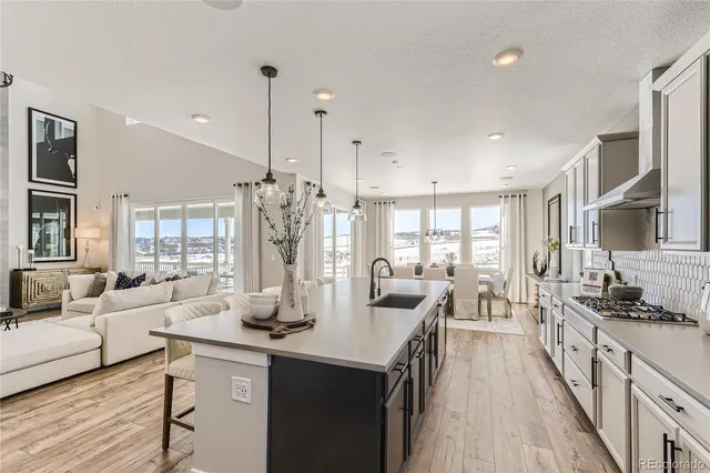 a view of a a dining room with furniture window and wooden floor