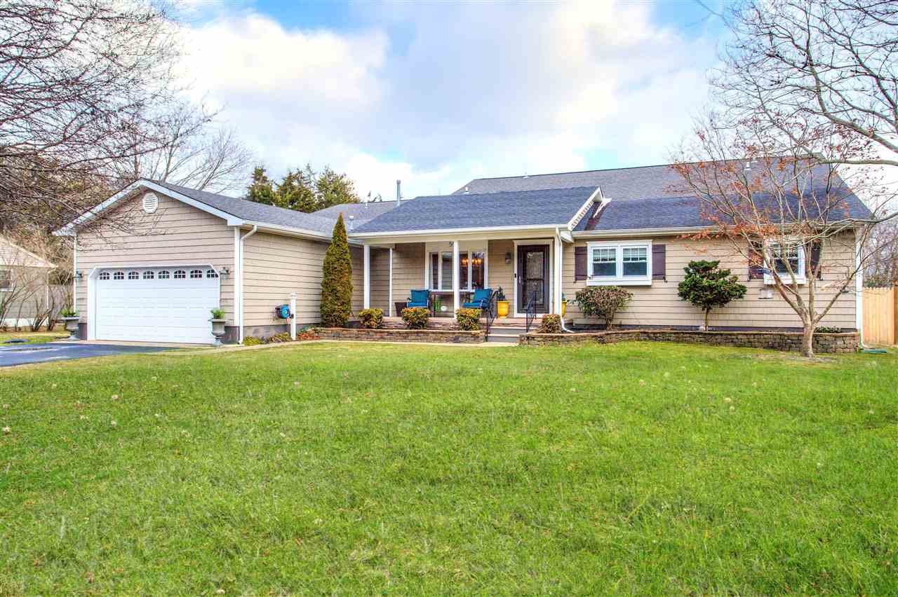 a view of a house with a backyard and a patio