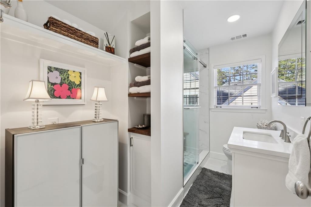 101 Dartmouth Avenue Avondale Estates, GA 30002 - Photo 30 of 53 a bathroom with a sink a toilet and a shower curtain