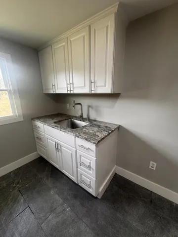 a spacious bathroom with a sink and a mirror