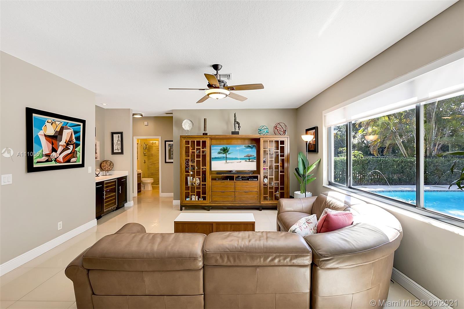 19124 Seneca Avenue Weston, FL 33332 - Photo 13 of 38 a living room with furniture a fireplace and a large window