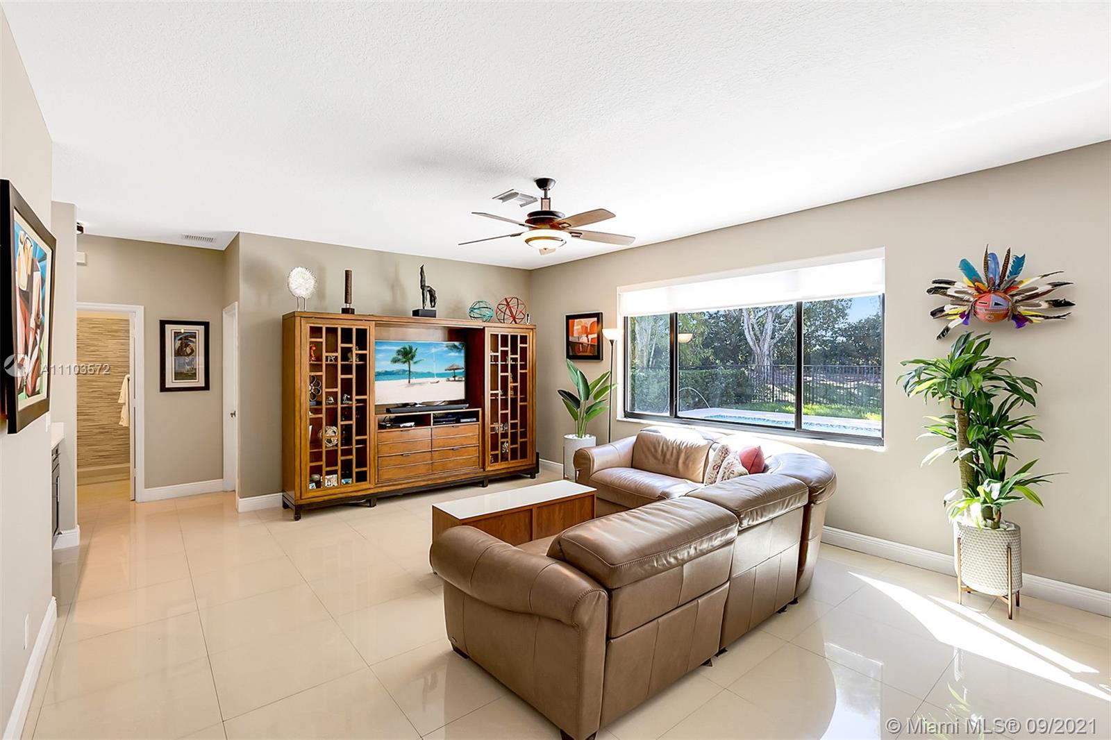 19124 Seneca Avenue Weston, FL 33332 - Photo 14 of 38 a living room with furniture and a large window
