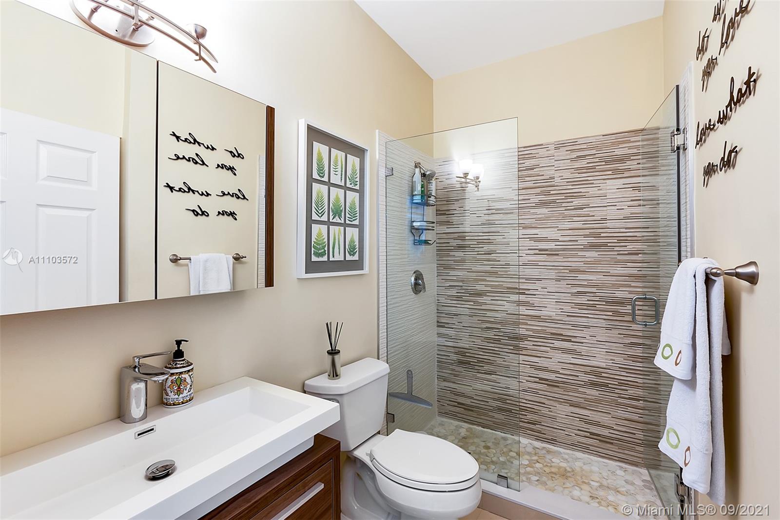 19124 Seneca Avenue Weston, FL 33332 - Photo 15 of 38 a bathroom with a sink a toilet and shower