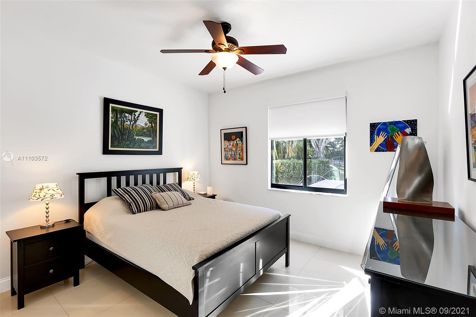 19124 Seneca Avenue Weston, FL 33332 - Photo 16 of 38 a bedroom with a bed and a painting on the wall