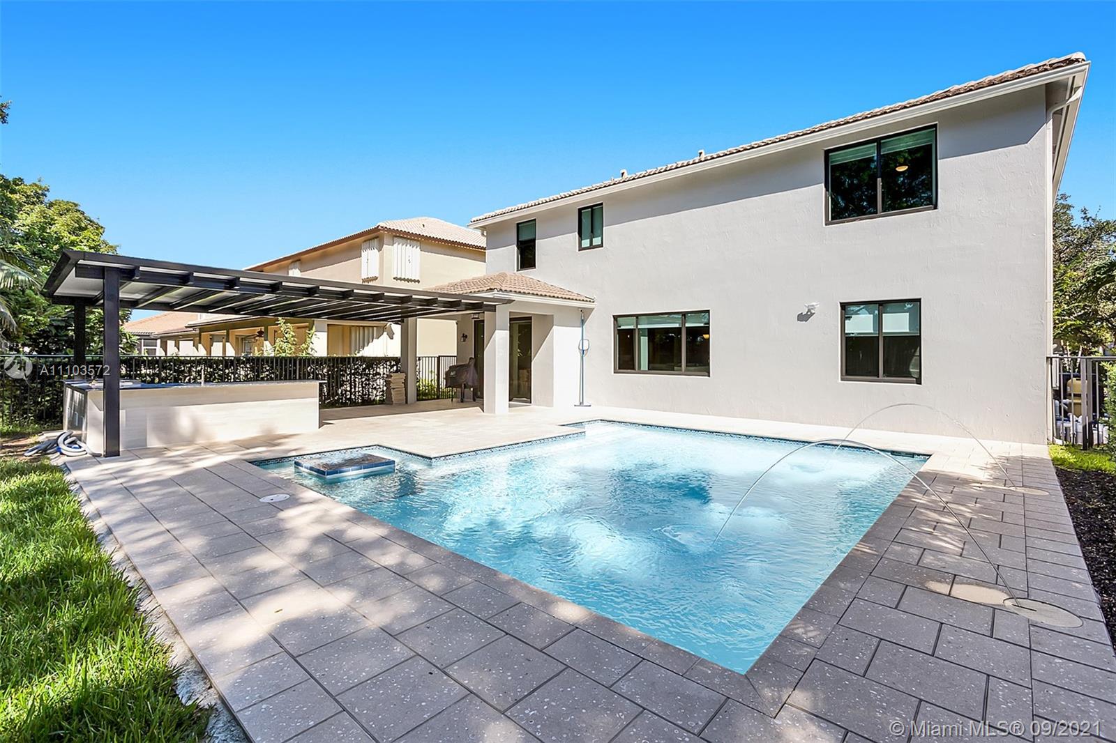 19124 Seneca Avenue Weston, FL 33332 - Photo 18 of 38 a view of a white house with a outdoor space