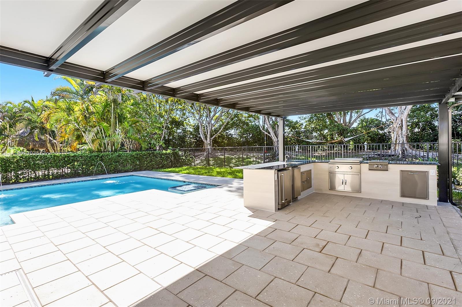19124 Seneca Avenue Weston, FL 33332 - Photo 20 of 38 a view of a swimming pool and a yard