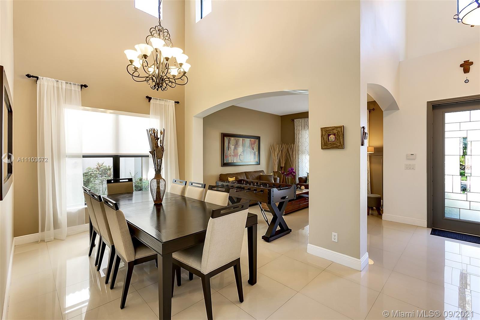 19124 Seneca Avenue Weston, FL 33332 - Photo 3 of 38 a view of a dining room with furniture and chandelier