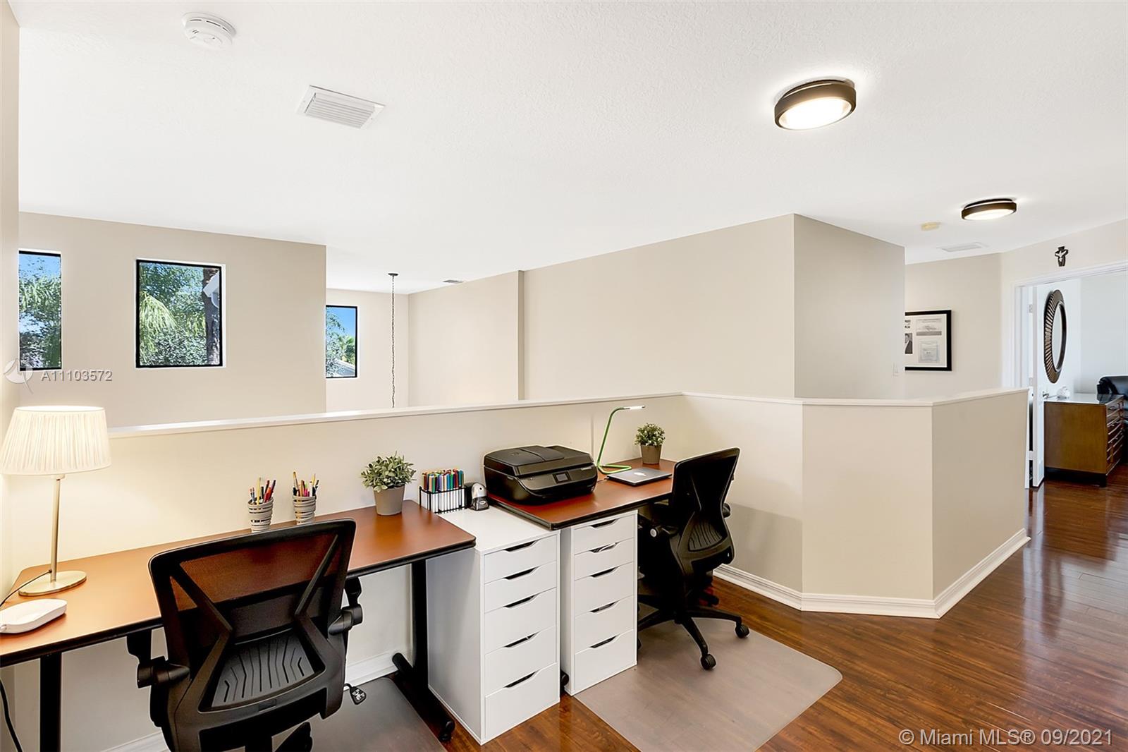 19124 Seneca Avenue Weston, FL 33332 - Photo 22 of 38 a view of workspace with furniture and wooden floor