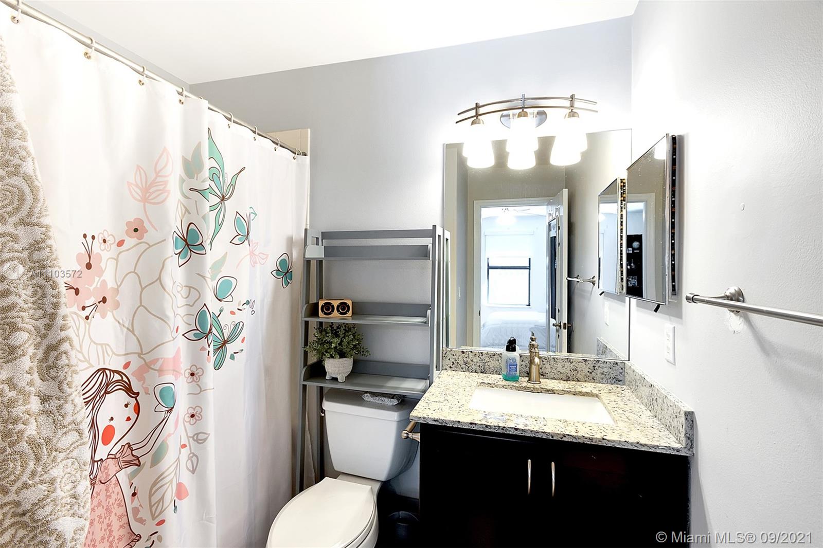 19124 Seneca Avenue Weston, FL 33332 - Photo 24 of 38 a bathroom with a granite countertop sink and a mirror