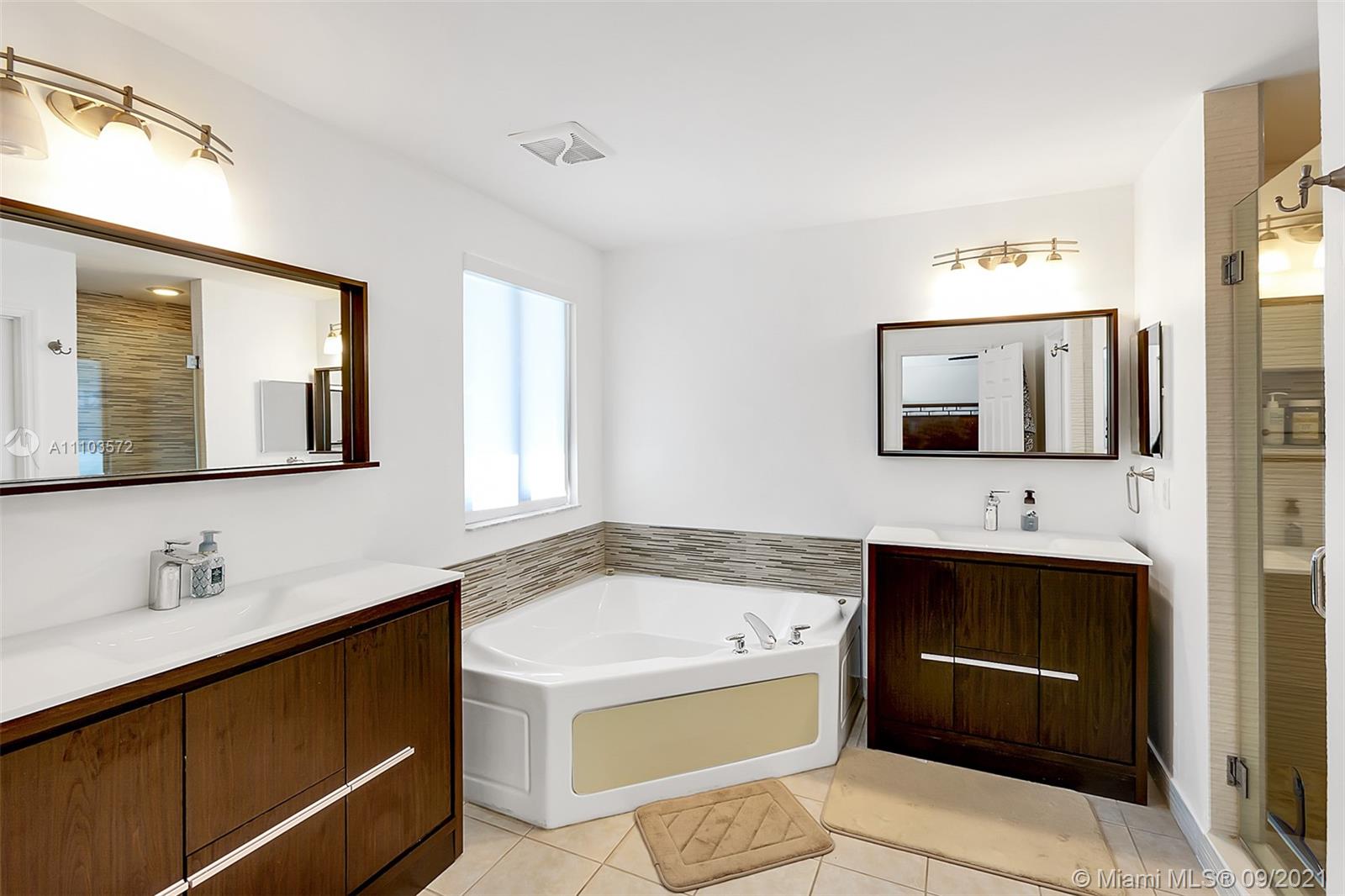 19124 Seneca Avenue Weston, FL 33332 - Photo 28 of 38 a bathroom with a sink and a mirror