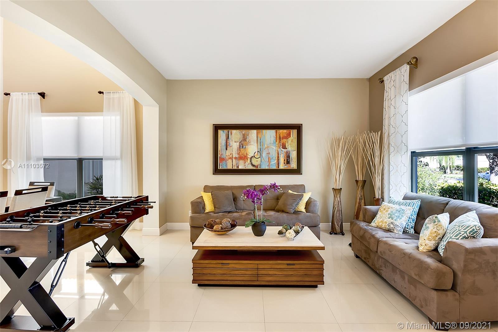 19124 Seneca Avenue Weston, FL 33332 - Photo 6 of 38 a living room with furniture and a flat screen tv with a large window