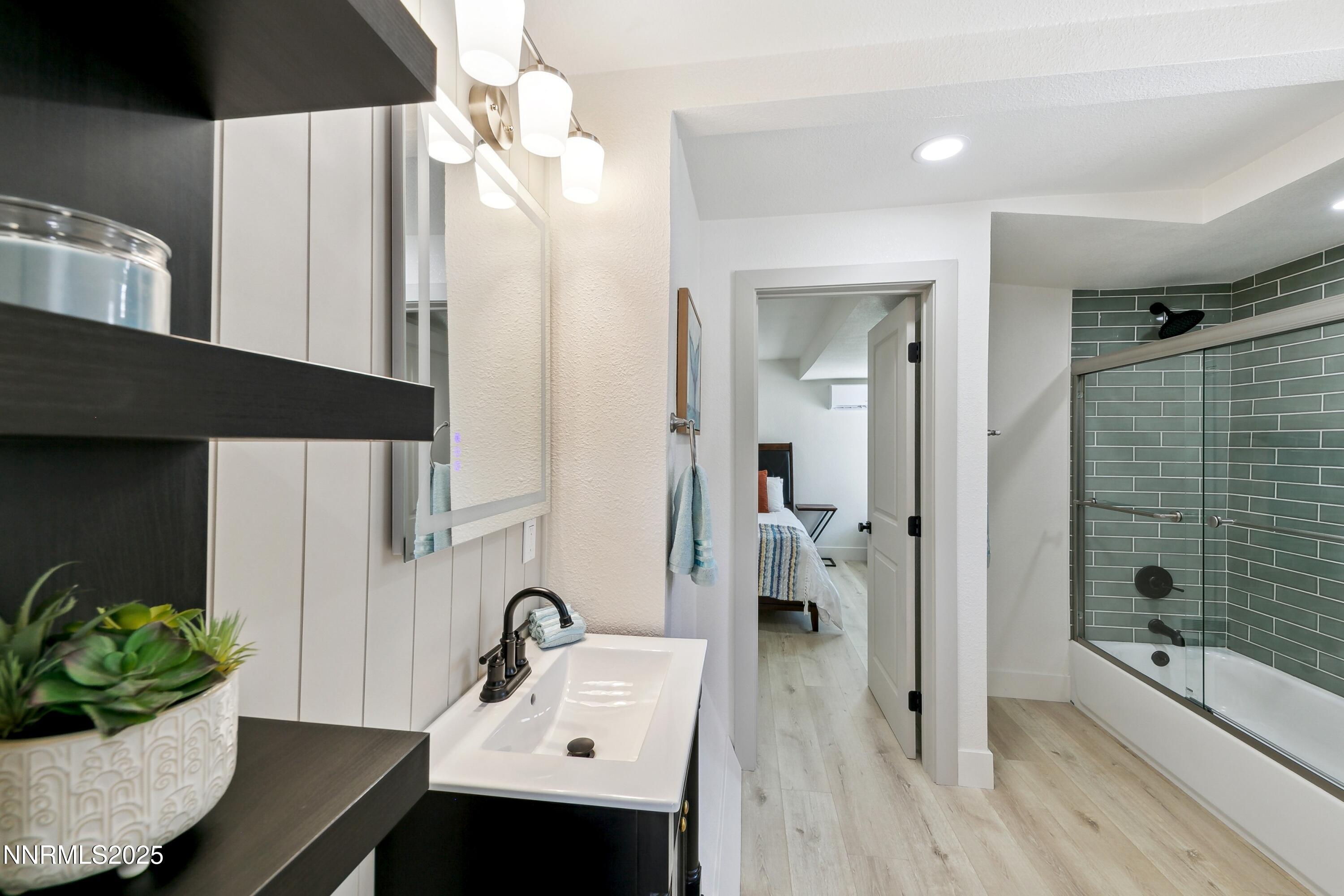 728 West Pueblo Street Reno, NV 89509 - Photo 17 of 33 a bathroom with a sink double vanity mirror and shower