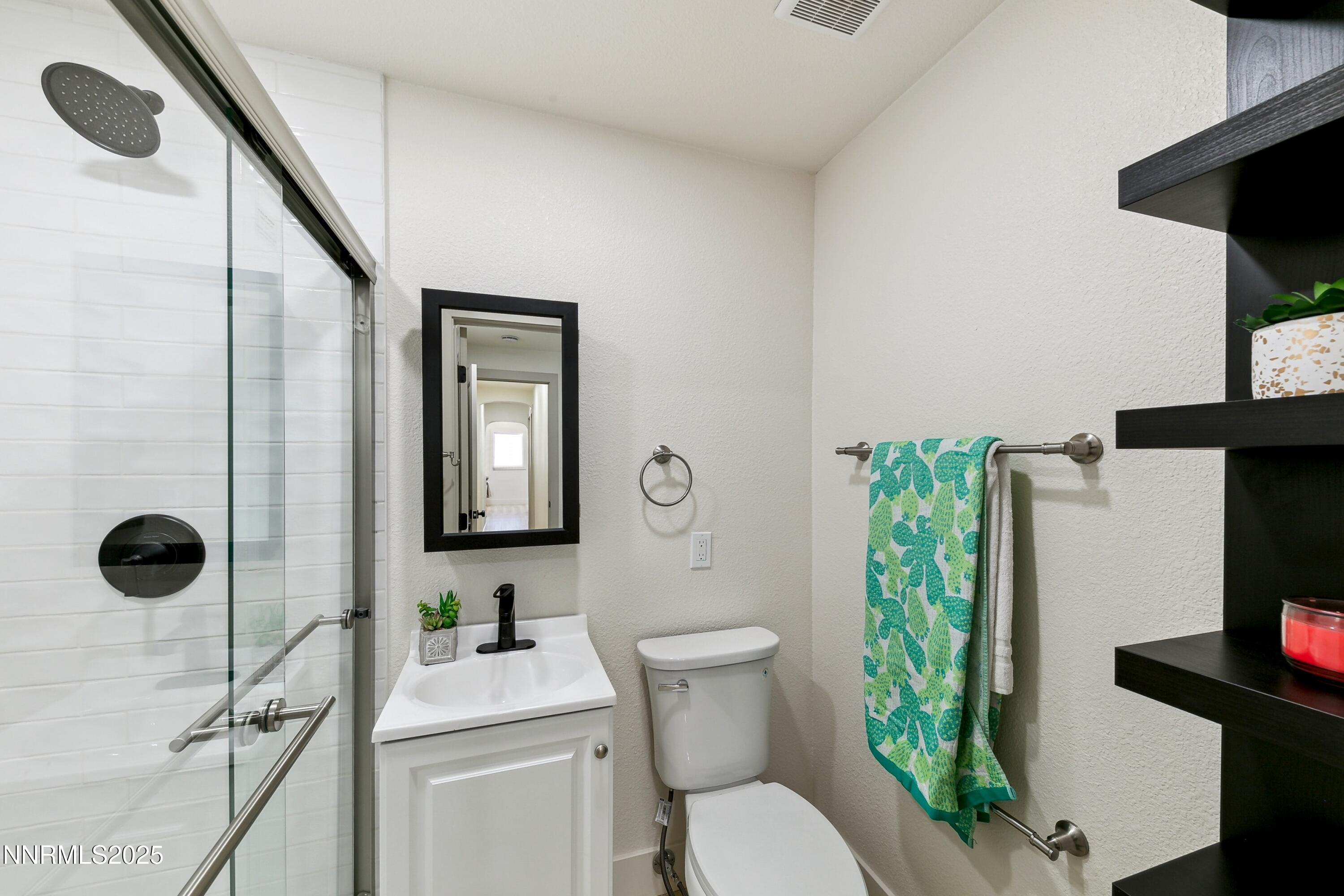 728 West Pueblo Street Reno, NV 89509 - Photo 21 of 33 a bathroom with a toilet sink and mirror