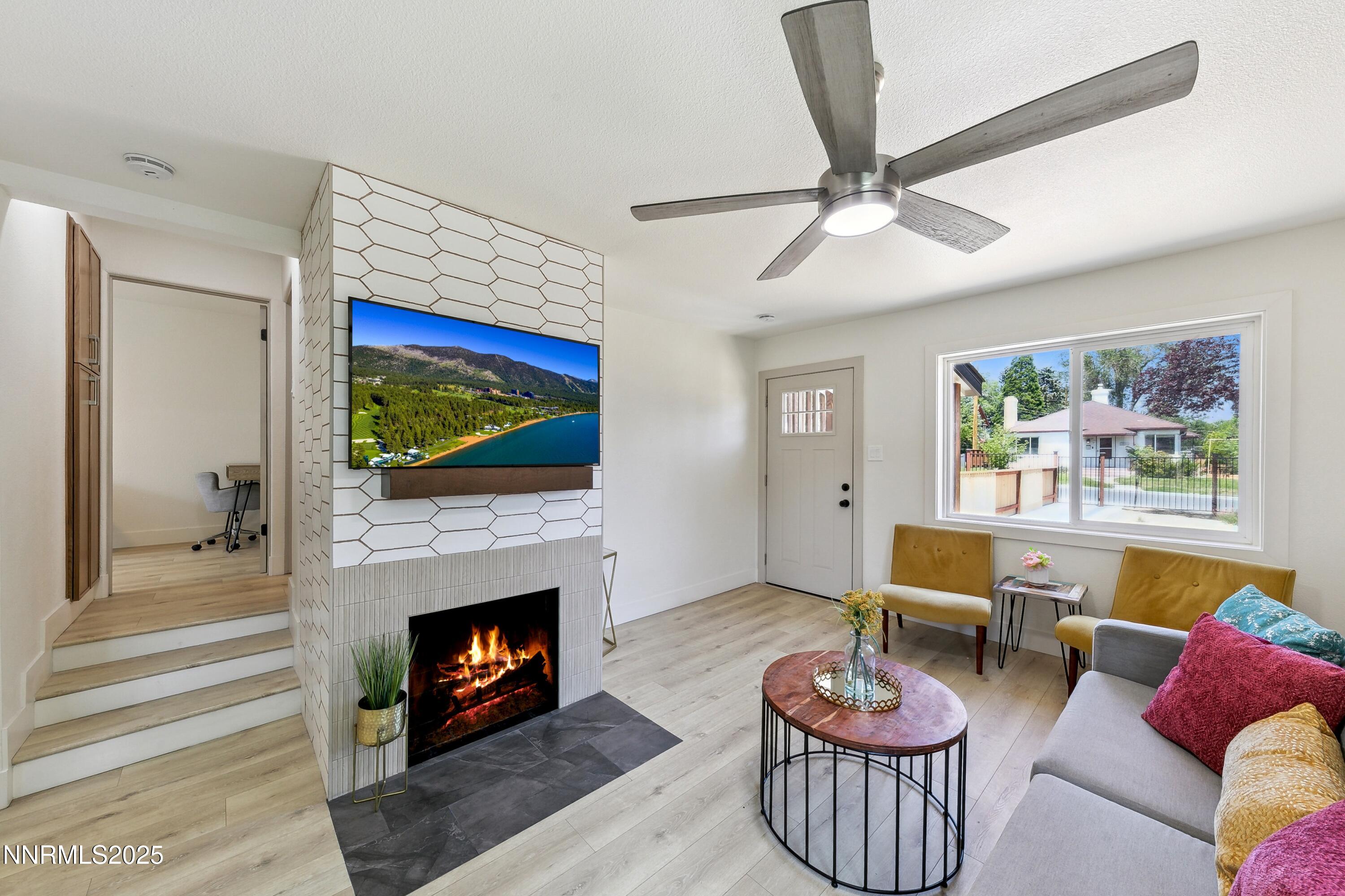 728 West Pueblo Street Reno, NV 89509 - Photo 26 of 33 a living room with furniture a fireplace and a flat screen tv