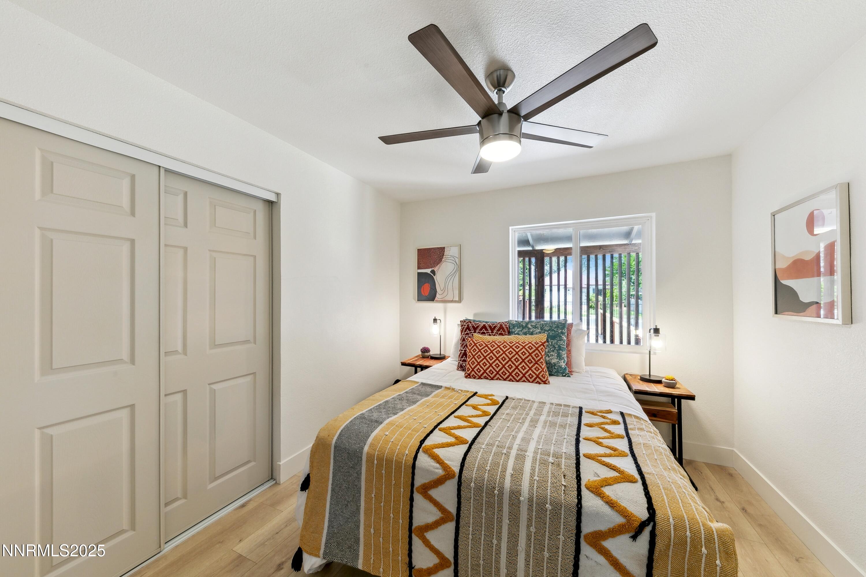 728 West Pueblo Street Reno, NV 89509 - Photo 33 of 33 a bedroom with a large bed and a chandelier