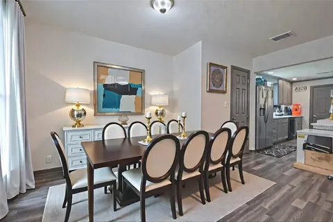 a bedroom with a bed a lamp and a dresser