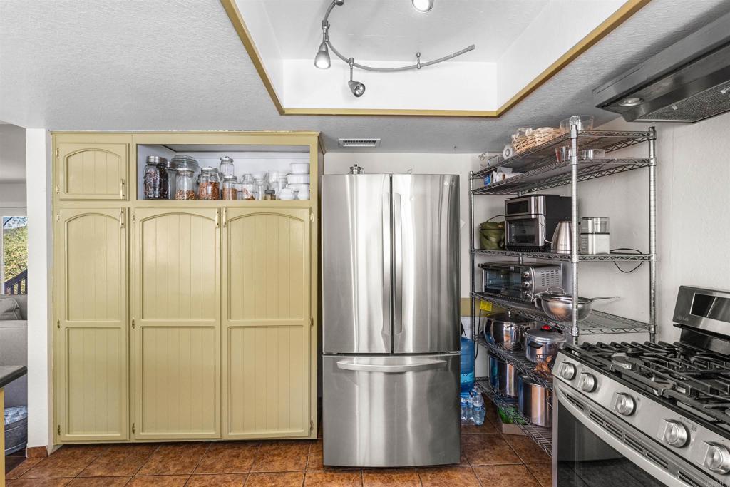 3340 Skytrail Ranch Road Jamul, CA 91935 - Photo 12 of 38 a kitchen with stainless steel appliances granite countertop a refrigerator and a stove