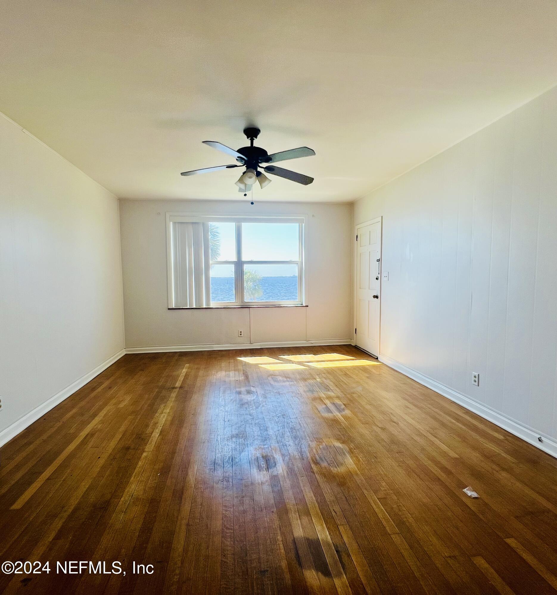 1781 River Road, Unit 4 Jacksonville, FL 32207 - Photo 6 of 24 an empty room with wooden floor and windows