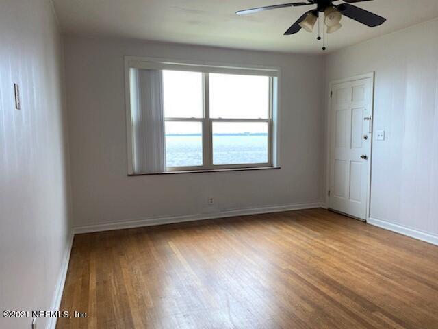 1781 River Road, Unit 4 Jacksonville, FL 32207 - Photo 7 of 24 an empty room with wooden floor and windows
