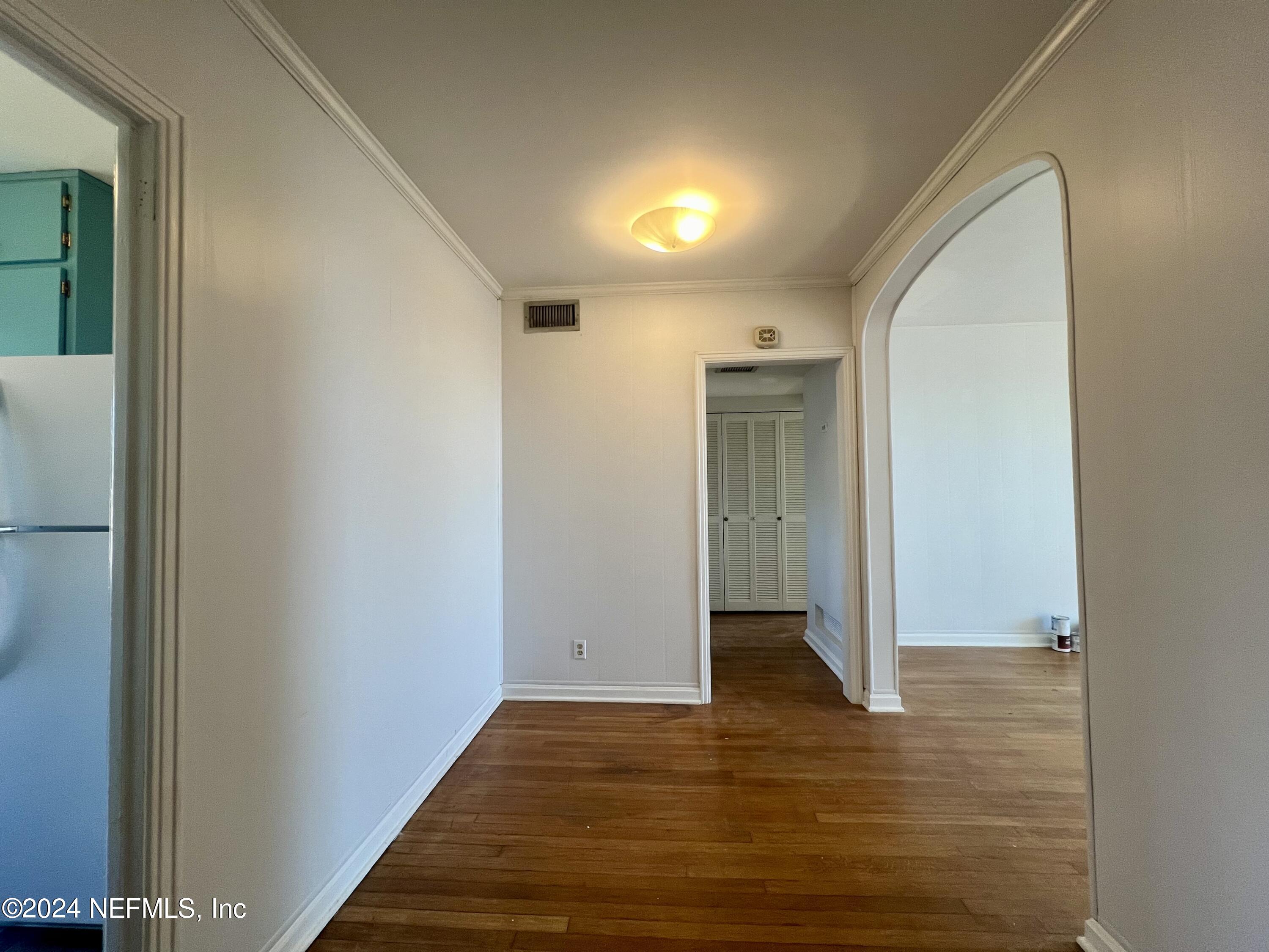 1781 River Road, Unit 4 Jacksonville, FL 32207 - Photo 10 of 24 a view of an empty room with wooden floor and a window